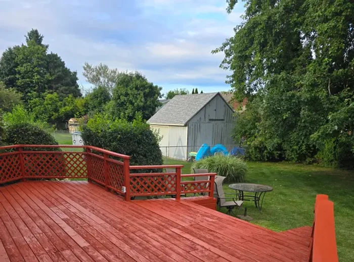 Backyard deck after sanding, board replacement, and re-staining